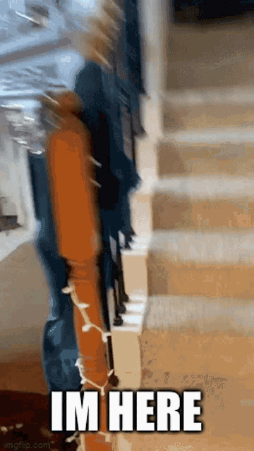 a blurry picture of a person standing on stairs with the words im here written on the bottom