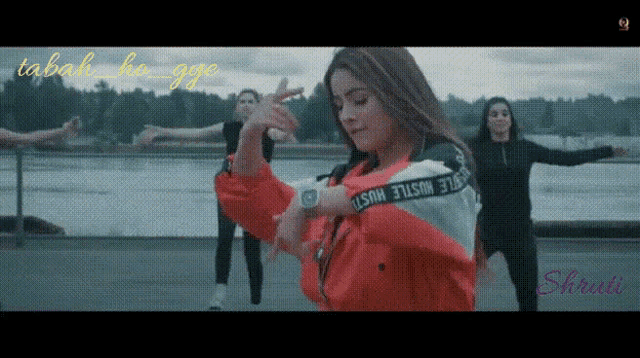 a woman in a red jacket with the word hustle on the sleeves