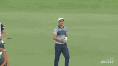 a man named rickie fowler is standing on a green