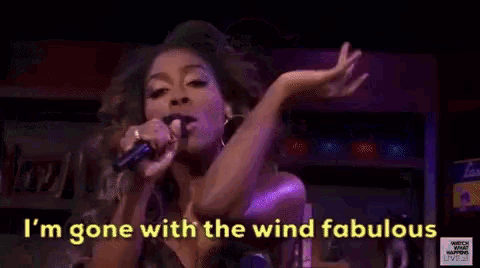 a woman is singing into a microphone with the words `` i 'm gone with the wind fabulous '' .