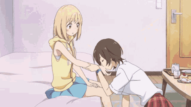 a girl in a yellow tank top is hugging another girl in a room