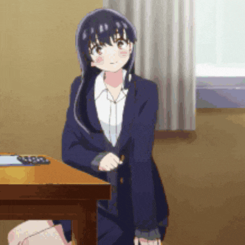a girl in a suit is standing in front of a desk .