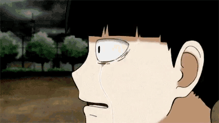 a close up of a cartoon character 's face with a tear running down his face .