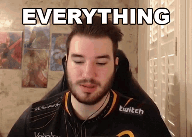 a man with a beard wearing a twitch shirt