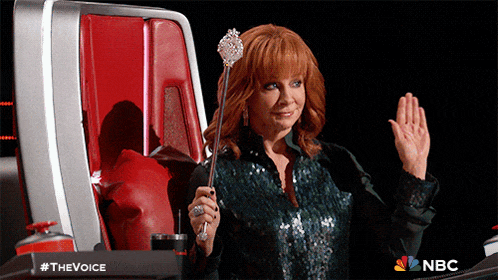a woman in a green sequined top is holding a wand in front of a nbc logo