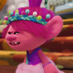 a troll with purple hair and a crown of flowers on her head