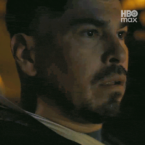 a close up of a man with a beard and a hbo max logo in the corner