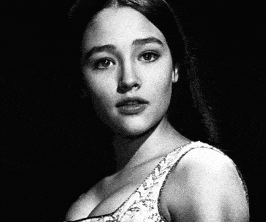 a black and white photo of a woman in a white top