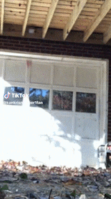 a white garage door with a tiktok logo on the side of it