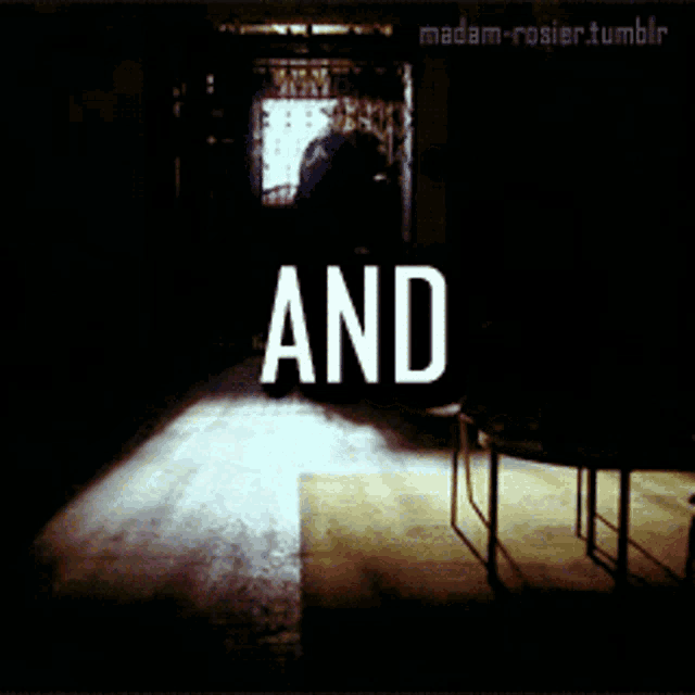 a dark room with the word and in white