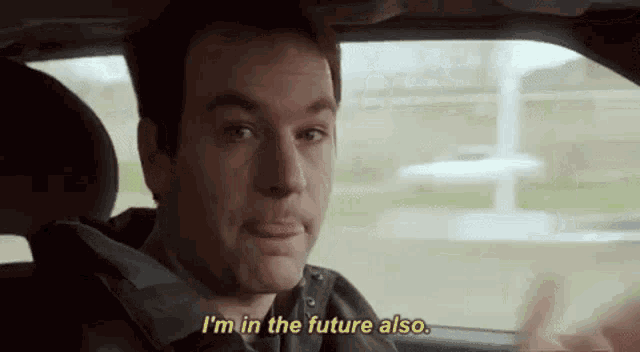 a man is sitting in the driver 's seat of a car and says `` i 'm in the future also '' .