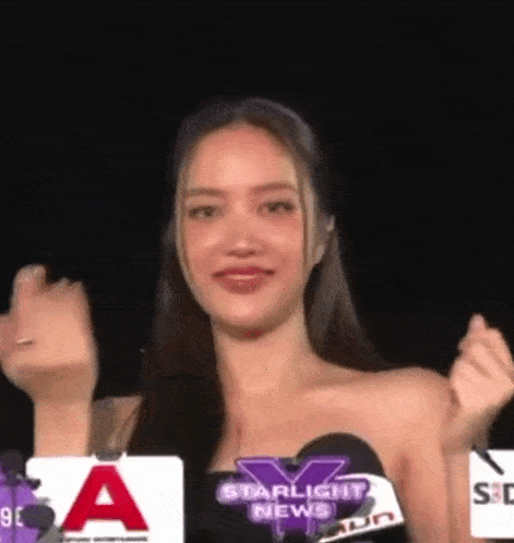 a woman is standing in front of a microphone with a sign that says starlight news on it .
