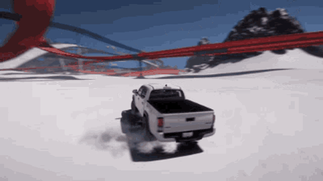 a white truck is driving through a snowy area