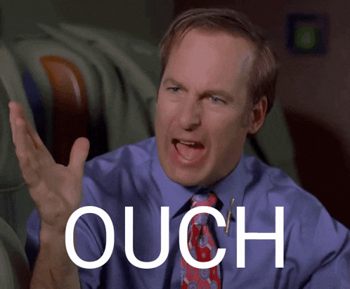 a man in a blue shirt and tie says ouch in front of his face