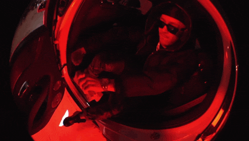 a person sitting in a car with red lights on