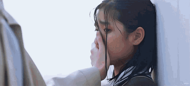 a man is touching a woman 's face while she is crying .