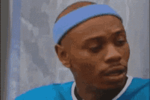 a man wearing a blue headband with the word wolverines on it