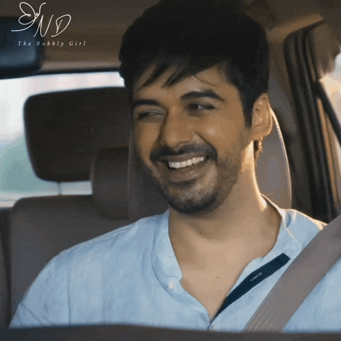 a man is smiling in a car with the words the bubbly girl on the bottom