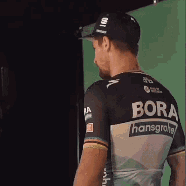 a man wearing a black shirt that says bora on it