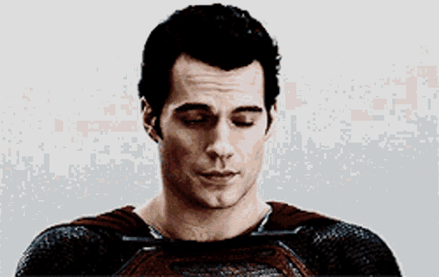 a close up of a man in a superman costume looking down