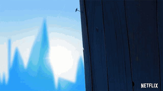 a netflix ad shows a wooden fence with a mountain in the background