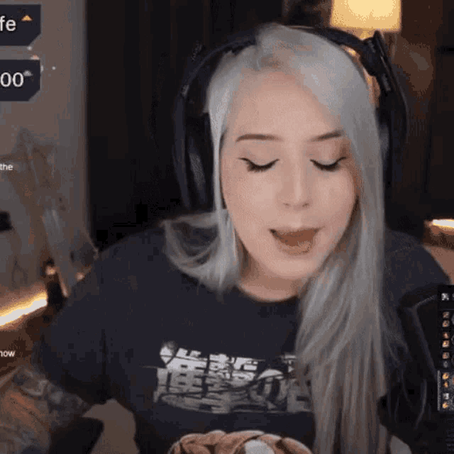 a woman wearing headphones and a t-shirt with a lion on it