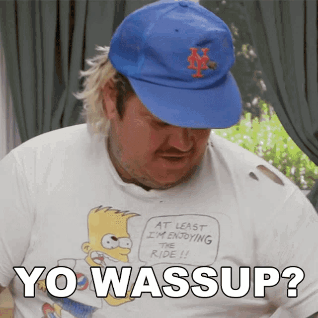 a man wearing a bart simpson t-shirt and a blue hat says yo wassup