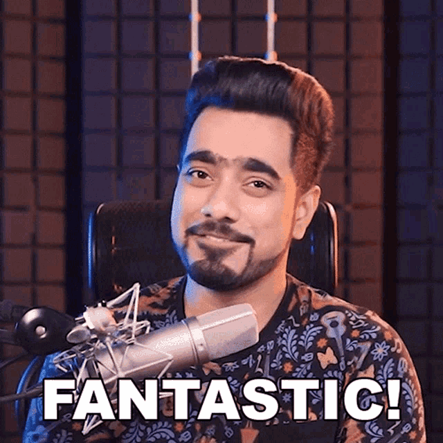 a man sitting in front of a microphone with the words fantastic on the bottom