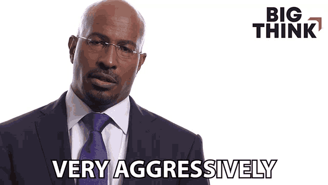 a man in a suit and tie says very aggressively in front of a big think logo