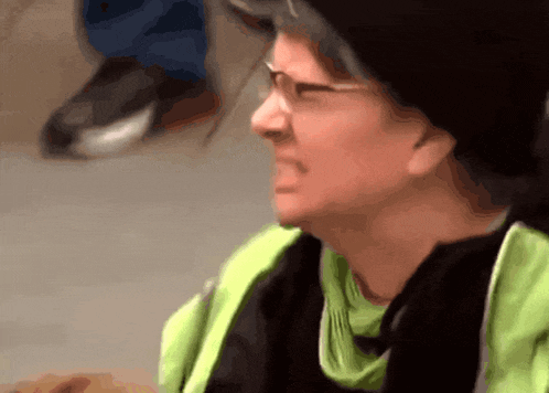 a woman wearing glasses and a green scarf