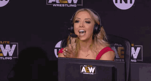 a woman wearing headphones and a monitor that says aew wrestling on it