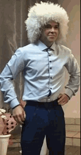 a man is wearing a white wig and a blue shirt .