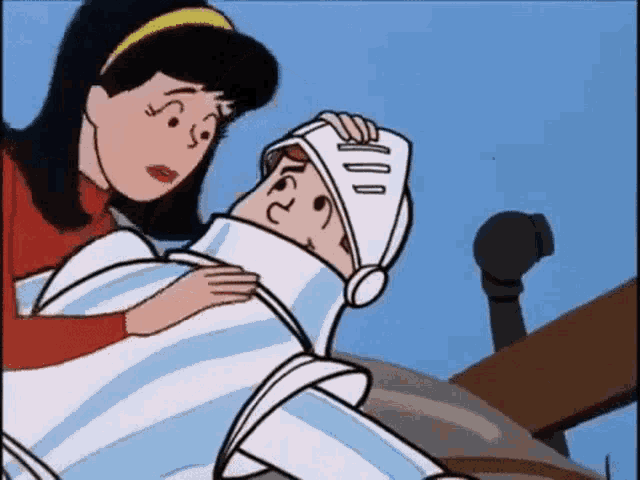 a woman is holding a man in a knight 's helmet in her arms .