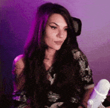 a woman is sitting in front of a microphone .