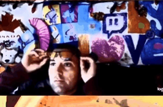 a man adjusts his glasses in front of a wall that has a speech bubble that says twitch