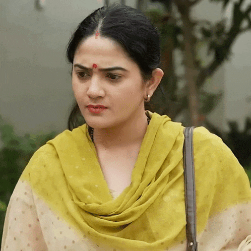 a woman with a yellow scarf around her neck