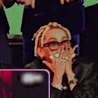 a woman with dreadlocks is covering her face with her hands .