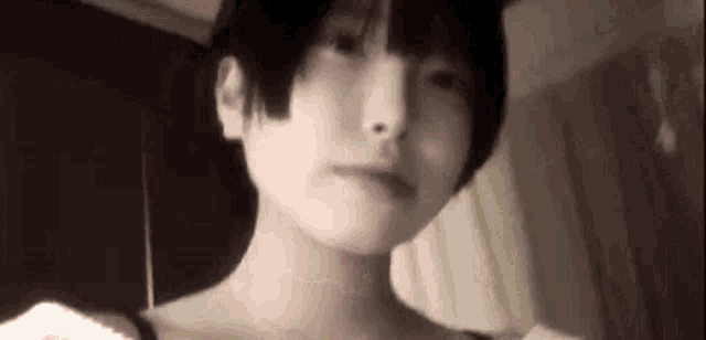 a close up of a woman 's face with short hair and a cat ear .
