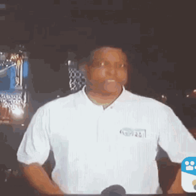 a man wearing a white shirt with the word abc on the front