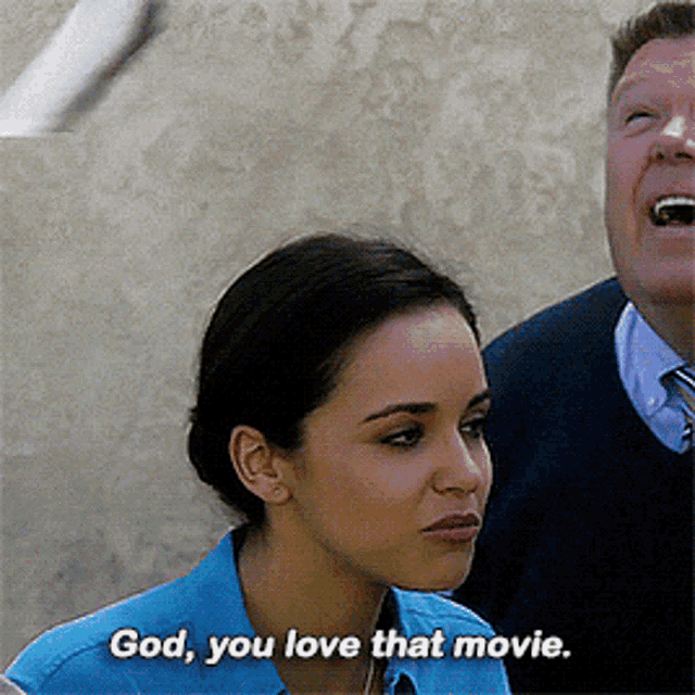 a woman says " god you love that movie " in front of a man