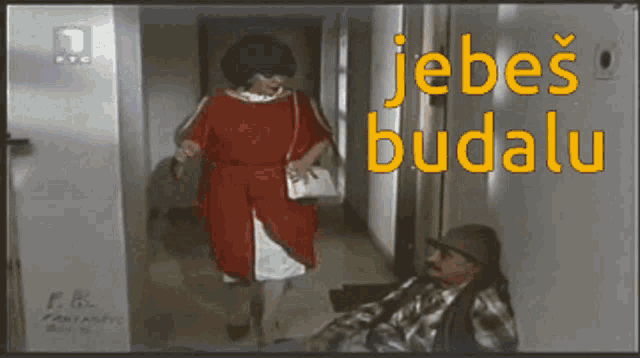 a woman in a red dress is standing next to a man in a plaid shirt with the words jebes budalu on the bottom