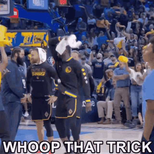 a basketball player with a bandage on his head is standing in front of a crowd and says whoop that trick