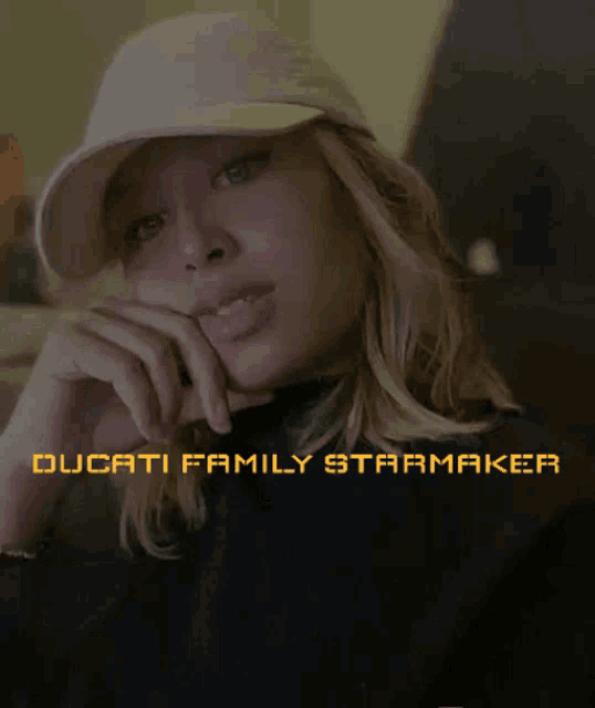 a woman wearing a hat is featured on a ducati family starmaker poster