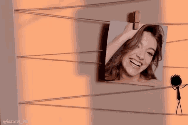 a picture of a woman with a red heart on her forehead hangs on a clothesline