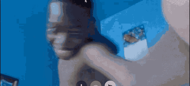 a man without a shirt is having a video call