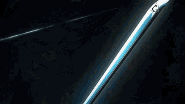 a close up of a sword with water coming out of it and a black background .