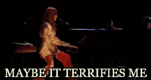 a woman singing into a microphone with the words " maybe it terrifies me " below her