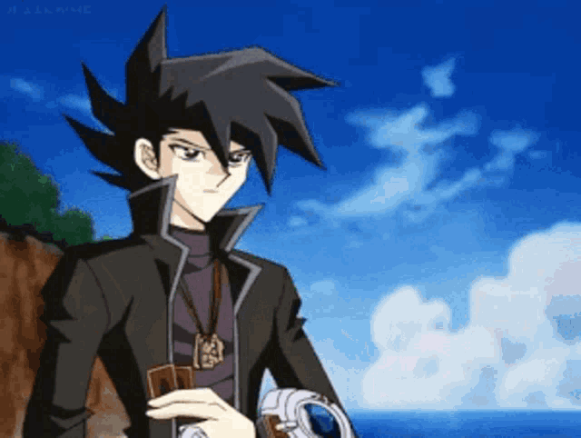 a man in a black jacket holds a card in his right hand