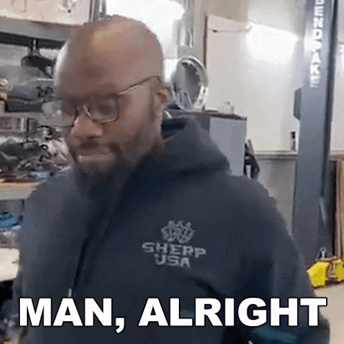 a man wearing glasses and a black hoodie says man , alright