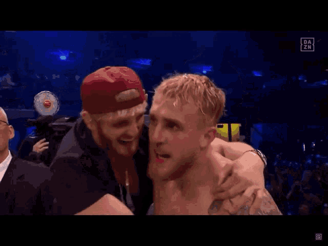 a man with a bandage on his face is being carried by a man in a red hat